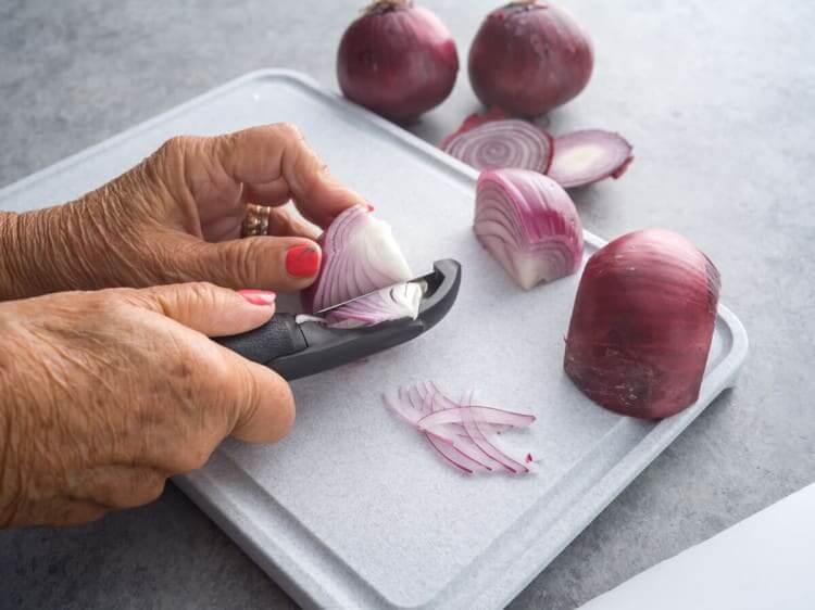 Peeling an onion with a vegetable peeler